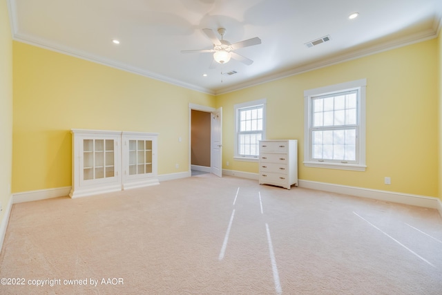 unfurnished bedroom featuring ceiling fan, light colored carpet, and ornamental molding