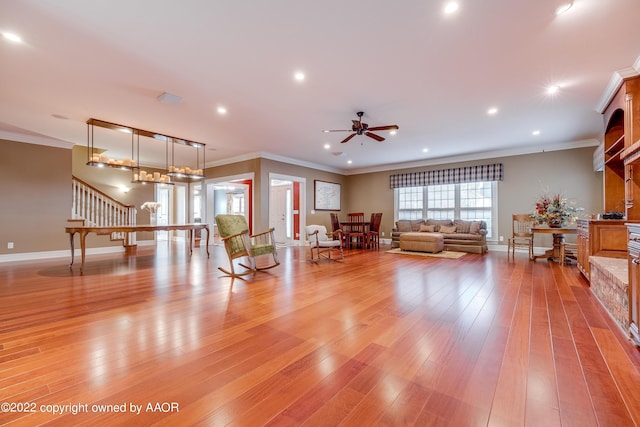 unfurnished living room featuring ceiling fan, crown molding, and light hardwood / wood-style floors