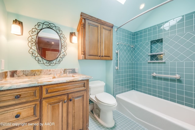 full bathroom featuring tile patterned floors, vanity, toilet, and tiled shower / bath