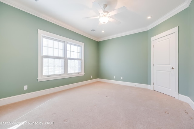 spare room with carpet, ceiling fan, and crown molding