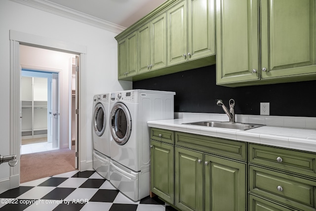 clothes washing area with cabinets, independent washer and dryer, crown molding, and sink