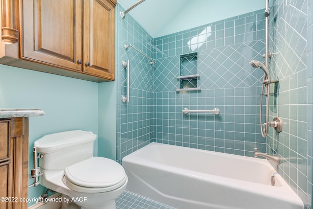 bathroom featuring tile patterned floors, tiled shower / bath, and toilet