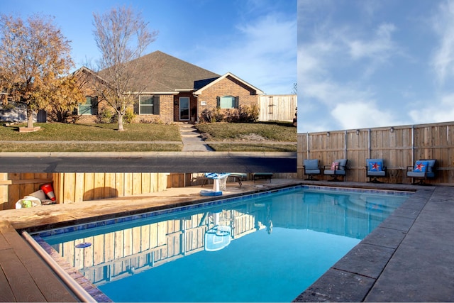 view of pool with a yard