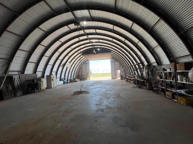 miscellaneous room featuring lofted ceiling and concrete flooring