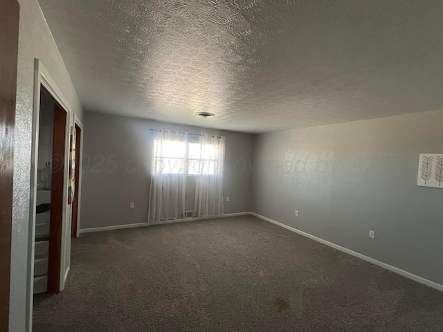 carpeted spare room with a textured ceiling