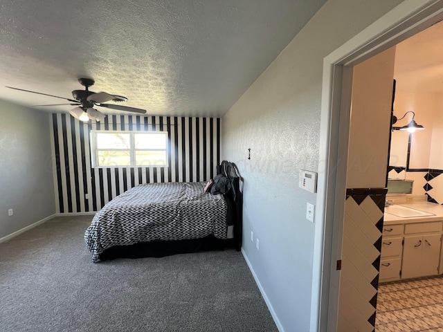 bedroom featuring ceiling fan, light carpet, and a textured ceiling