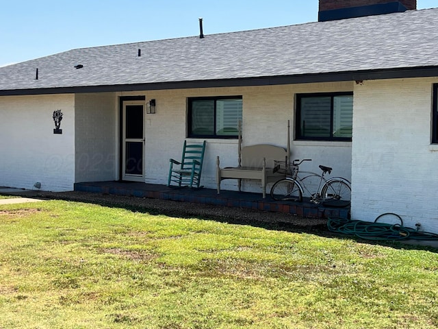 rear view of property featuring a yard