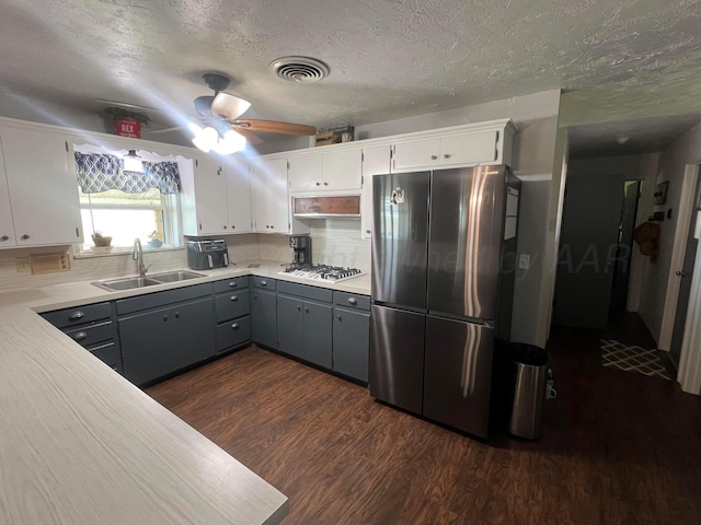 kitchen with sink, stainless steel fridge, gray cabinetry, white cabinets, and white gas cooktop