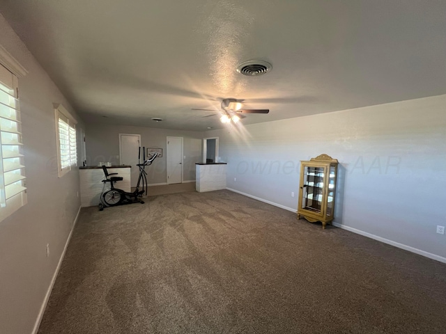 interior space with carpet floors and ceiling fan