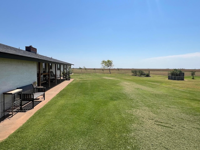 view of yard featuring a patio and a rural view