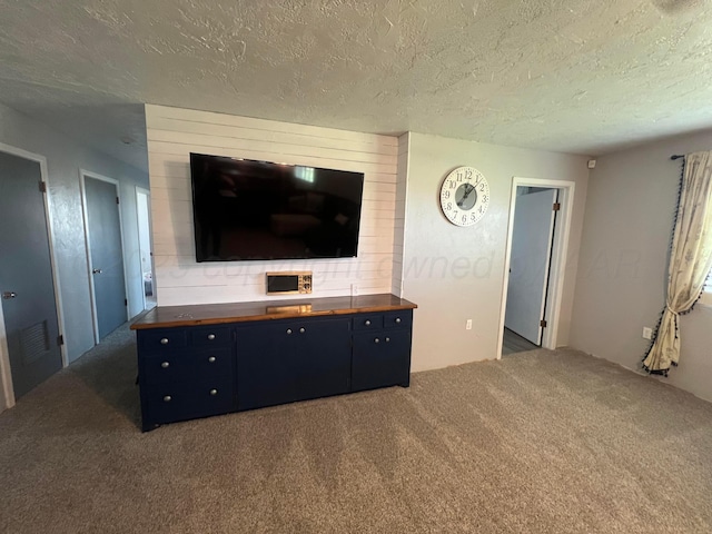 carpeted living room with a textured ceiling