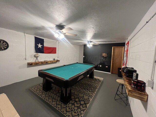 playroom featuring concrete flooring, ceiling fan, pool table, and a textured ceiling