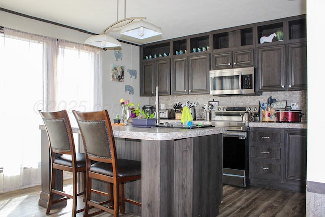 420 N 18th St, Memphis, TX 79245 - kitchen featuring dark wood-style floors, stainless steel appliances, and dark brown cabinets