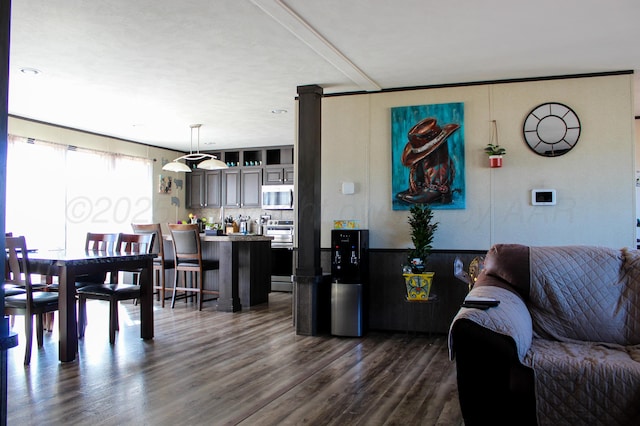 420 N 18th St, Memphis, TX 79245 - living room featuring dark wood-style flooring and a wainscoted wall