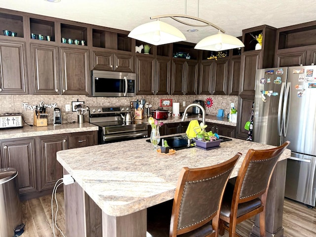 420 N 18th St, Memphis, TX 79245 - kitchen featuring open shelves, dark brown cabinetry, tasteful backsplash, and stainless steel appliances