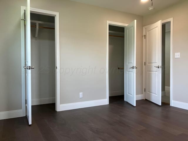 3704 Westlawn Ave, Amarillo, TX 79102 - unfurnished bedroom with dark wood-style flooring and multiple closets