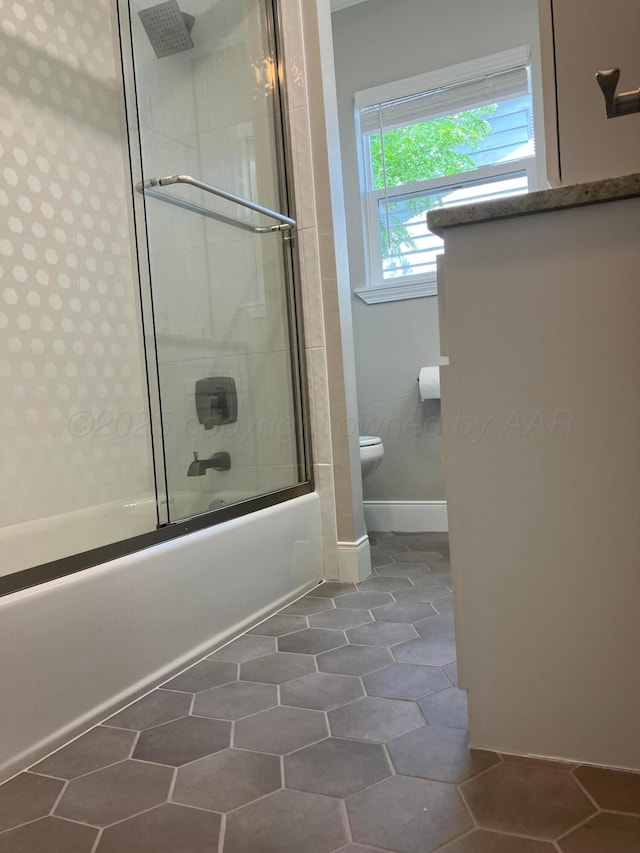 3704 Westlawn Ave, Amarillo, TX 79102 - bathroom with toilet and bath / shower combo with glass door