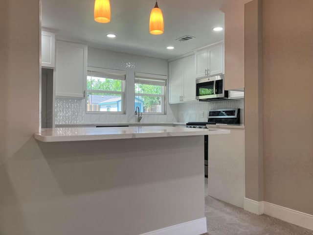 3704 Westlawn Ave, Amarillo, TX 79102 - kitchen featuring appliances with stainless steel finishes, white cabinetry, light countertops, backsplash, and recessed lighting