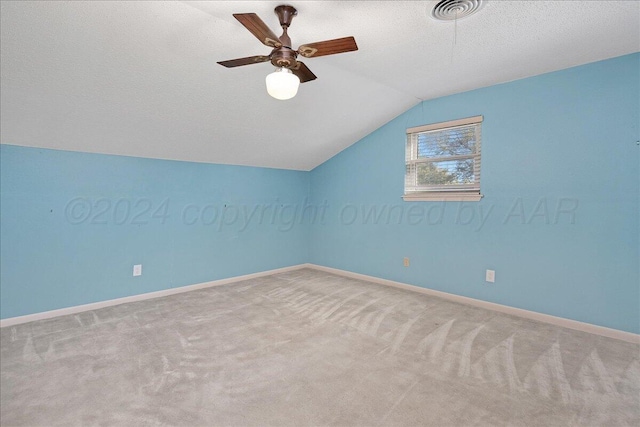 bonus room with a textured ceiling, light colored carpet, ceiling fan, and lofted ceiling