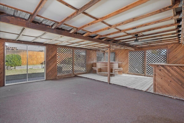 interior space featuring carpet and wood walls