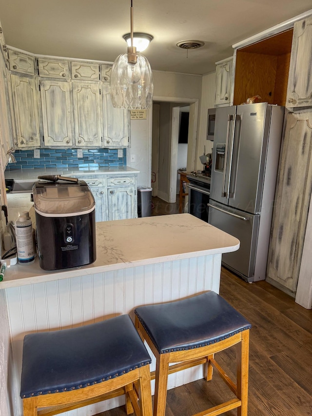 1105 Main St, Panhandle, TX 79068 - kitchen featuring high end refrigerator, a peninsula, backsplash, dark wood-type flooring, and light countertops