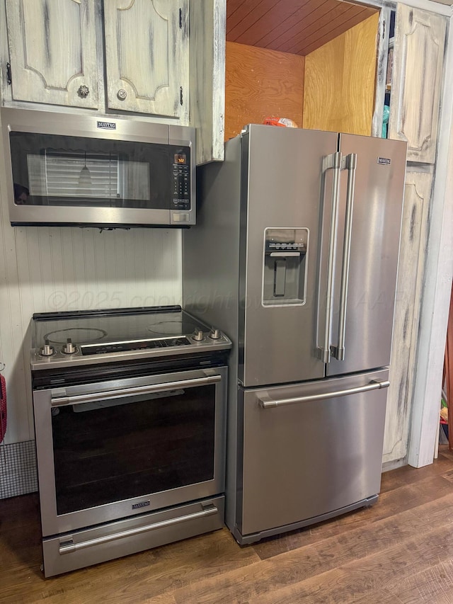 1105 Main St, Panhandle, TX 79068 - kitchen featuring appliances with stainless steel finishes and dark wood-type flooring