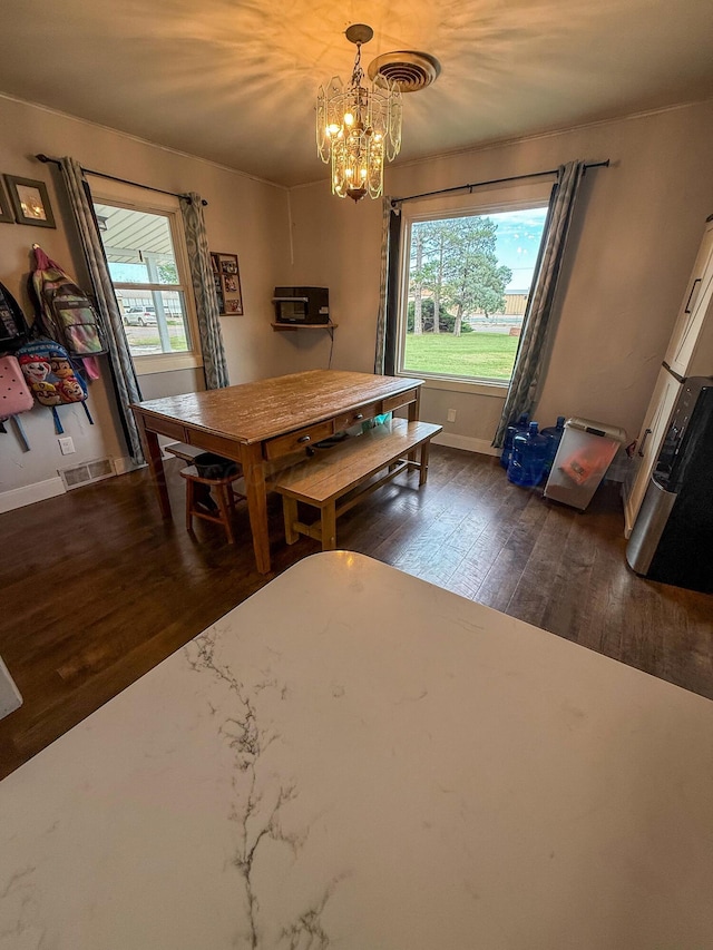 1105 Main St, Panhandle, TX 79068 - dining space with dark wood finished floors and a chandelier