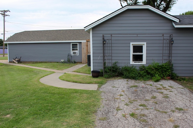 1105 Main St, Panhandle, TX 79068 - rear view of house with a lawn, a shingled roof, and cooling unit