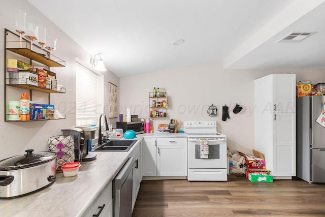 kitchen featuring wood-type flooring, white cabinetry, sink, and appliances with stainless steel finishes