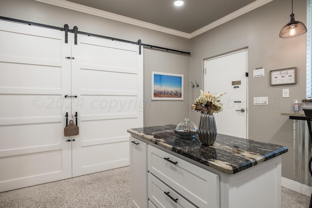 kitchen featuring pendant lighting, white cabinetry, ornamental molding, and dark stone countertops