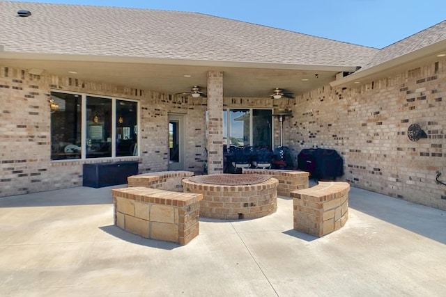 view of patio featuring ceiling fan, an outdoor fire pit, and grilling area