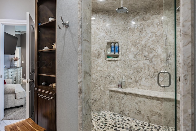 bathroom featuring an enclosed shower and crown molding