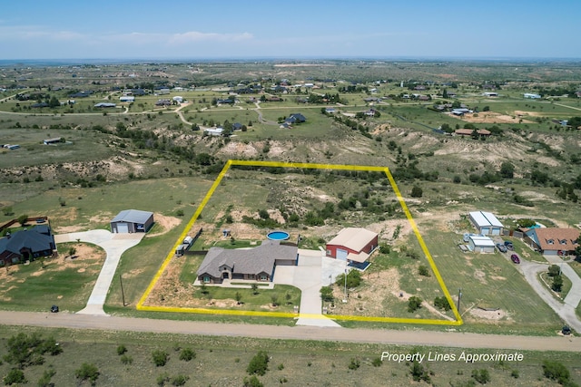 birds eye view of property featuring a rural view