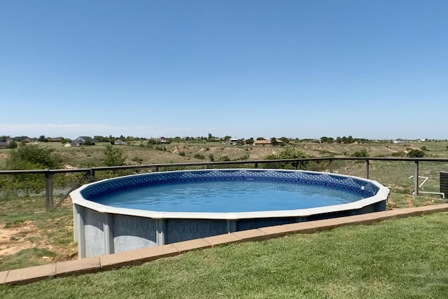 view of pool with cooling unit and a rural view