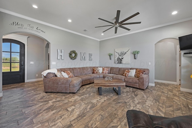 living room featuring dark hardwood / wood-style flooring, ceiling fan, and crown molding