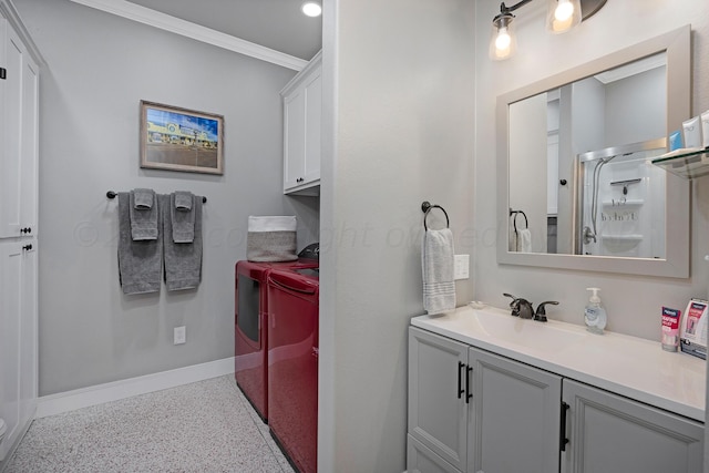 bathroom with vanity, washing machine and dryer, a shower with shower door, and crown molding