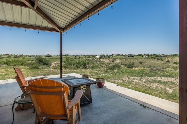 view of patio featuring a rural view and a fire pit