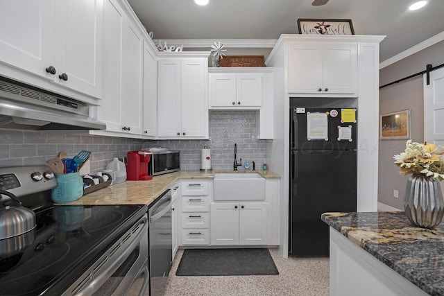 kitchen with a barn door, sink, white cabinets, and stainless steel appliances