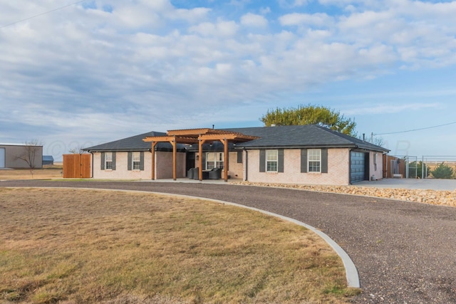 single story home with a garage and a pergola