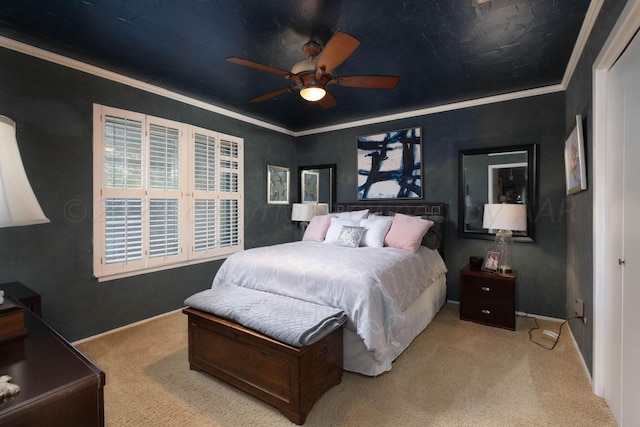 bedroom featuring carpet, ceiling fan, and crown molding