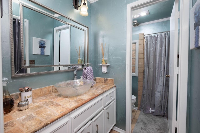 bathroom featuring crown molding, vanity, a shower with shower curtain, and toilet