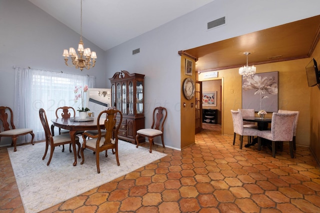 dining room featuring a notable chandelier and high vaulted ceiling