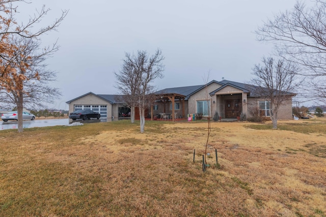 ranch-style home featuring a garage and a front lawn