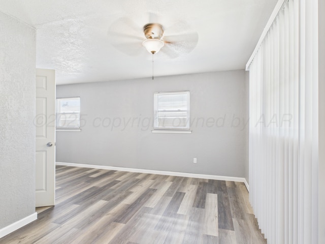 803 R Ave, Sunray, TX 79086 - empty room featuring wood finished floors and a ceiling fan