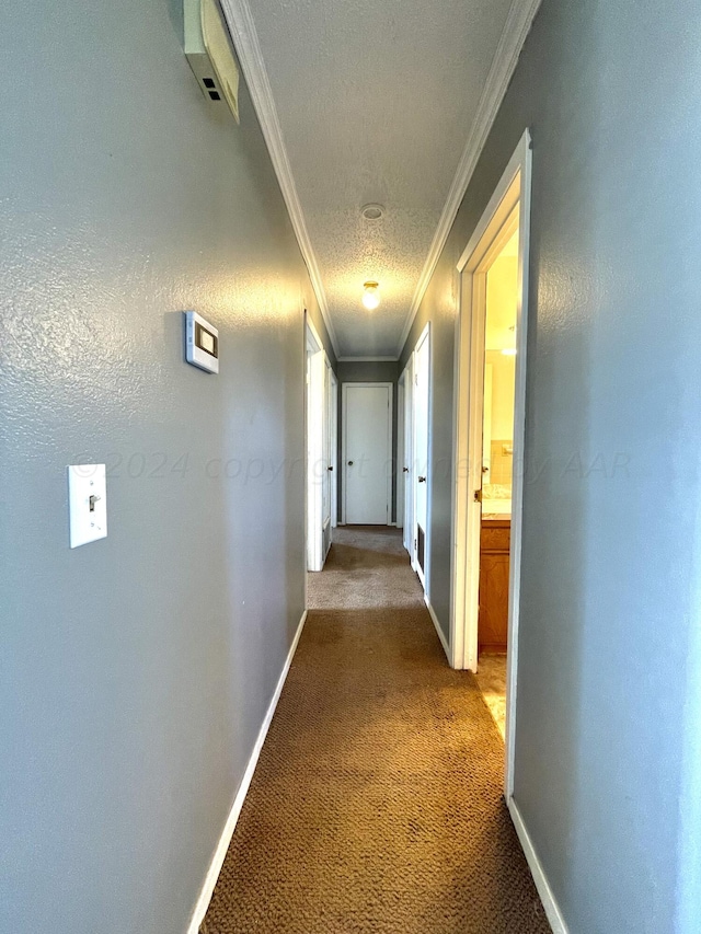 hall featuring crown molding, a textured ceiling, and carpet floors