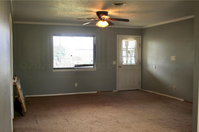 interior space with ornamental molding, a textured ceiling, carpet flooring, and ceiling fan