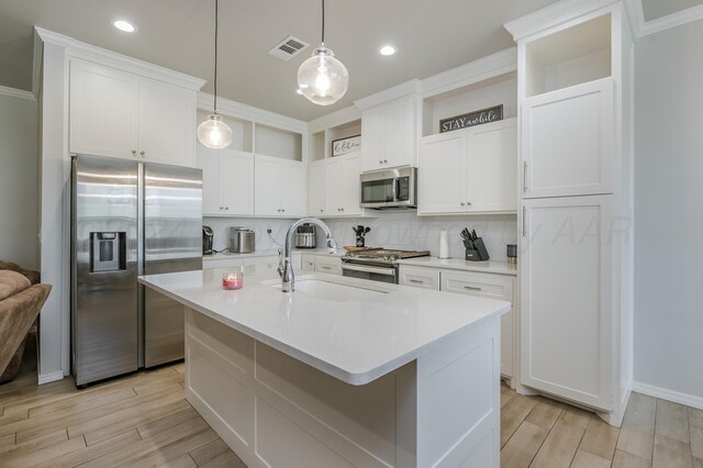 3005 Portland Ave, Amarillo, TX 79118 - kitchen with appliances with stainless steel finishes, decorative backsplash, light countertops, and white cabinetry
