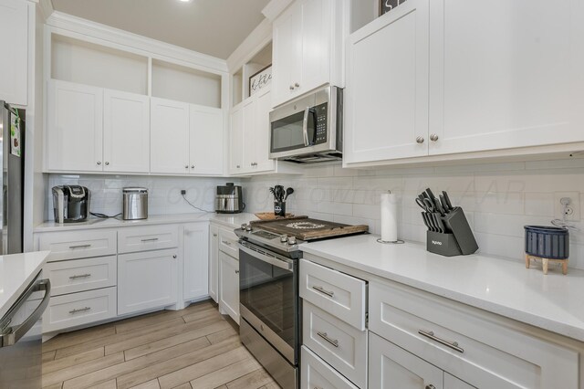 3005 Portland Ave, Amarillo, TX 79118 - kitchen with stainless steel appliances, a ceiling fan, open floor plan, decorative backsplash, and recessed lighting