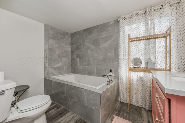 1033 Bowie St, Amarillo, TX 79102 - bathroom with wood finished floors, toilet, a relaxing tiled tub, and vanity