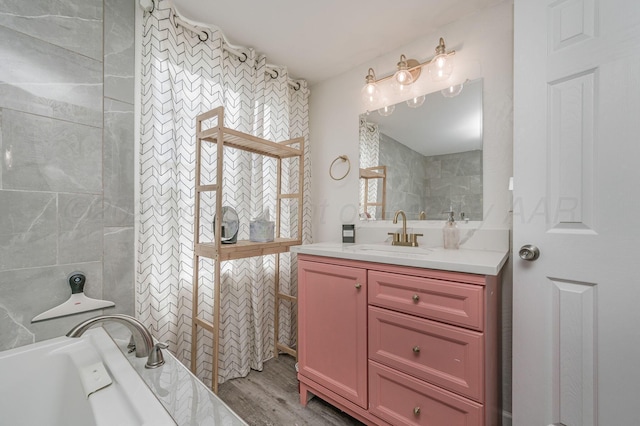 1033 Bowie St, Amarillo, TX 79102 - bathroom featuring vanity, a tub to relax in, and wood finished floors